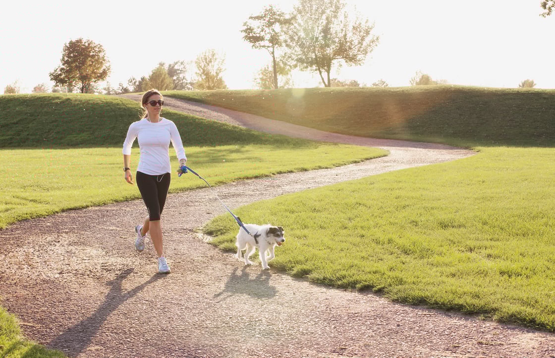 Woman Jogging with Dog - Hi Res